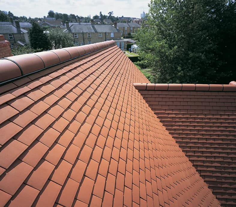 Close view of Sandtoft Humber clay plain tiles in Natural Red laid on a pitched roof